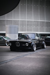 a black car parked in a parking lot